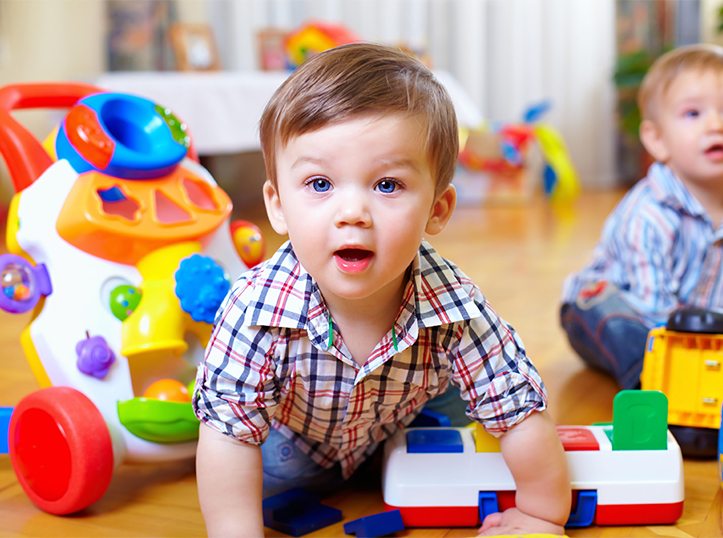 two toddlers playing with toys